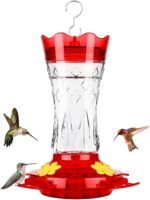 A red glass hummingbird feeder with star decorations, four feeding ports with perches, and a built-in ant moat.