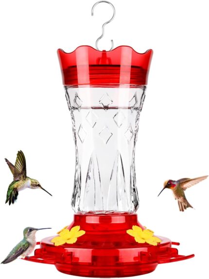 A red glass hummingbird feeder with star decorations, four feeding ports with perches, and a built-in ant moat.