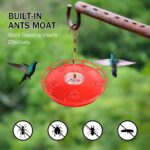Two pure red eWonLife saucer hummingbird feeders with clear bases, hanging outdoors among green foliage.
