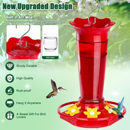Two vibrant red glass hummingbird feeders, hanging outdoors, with ant moats visible and flower-shaped feeding ports.