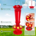 Two vibrant red glass hummingbird feeders, hanging outdoors, with ant moats visible and flower-shaped feeding ports.