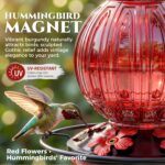 A vibrant red glass hummingbird feeder by Grete Gotye, hanging outdoors with five metal flower feeding ports.