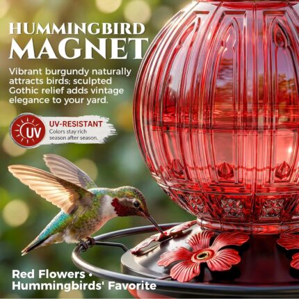 A vibrant red glass hummingbird feeder by Grete Gotye, hanging outdoors with five metal flower feeding ports.