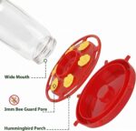 Two red Hpewi plastic hummingbird feeders with yellow flower feeding ports and ant moats, hanging outdoors.