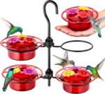 Four iBorn mini hummingbird feeders with red silicone flower feeding ports, hanging outdoors with a hummingbird nearby.