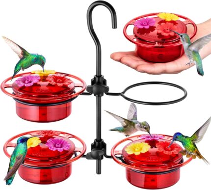 Four iBorn mini hummingbird feeders with red silicone flower feeding ports, hanging outdoors with a hummingbird nearby.