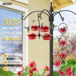 Four iBorn mini hummingbird feeders with red silicone flower feeding ports, hanging outdoors with a hummingbird nearby.