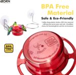 A vibrant red iBorn window hummingbird feeder with clear nectar reservoir, attached to a window pane via a large suction cup,