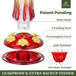 A vibrant Kingsyard Royal Red glass hummingbird feeder with a built-in ant moat and multiple feeding ports.