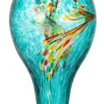 A vibrant blue hand-blown glass hummingbird feeder with five metal flower feeding ports and a built-in ant moat, hanging outd
