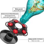A vibrant blue hand-blown glass hummingbird feeder with five metal flower feeding ports and a built-in ant moat, hanging outd