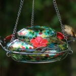 Vibrant blue sunset hand-blown glass hummingbird feeder with three feeding ports and a decorative hanging basket.