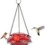A vibrant red, hand-blown glass hummingbird feeder with a decorative hanging basket and three feeding ports.