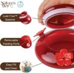 A vibrant red, hand-blown glass hummingbird feeder with a decorative hanging basket and three feeding ports.
