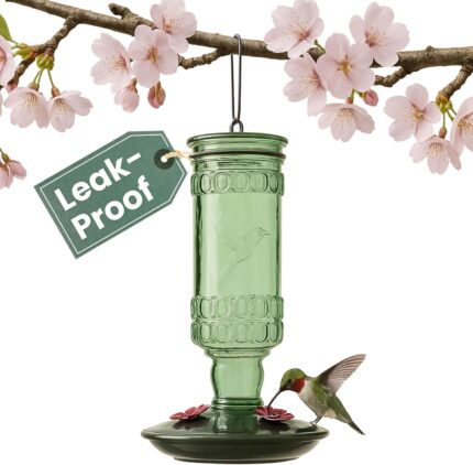 Perky-Pet Antique Green Glass Hummingbird Feeder with a brushed nickel base and four flower-shaped feeding ports, hanging out
