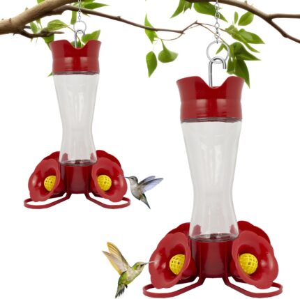 Two clear glass Perky-Pet hummingbird feeders with red flower feeding ports and U-shaped perches, hanging outdoors.