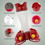 Two clear glass Perky-Pet hummingbird feeders with red flower feeding ports and U-shaped perches, hanging outdoors.