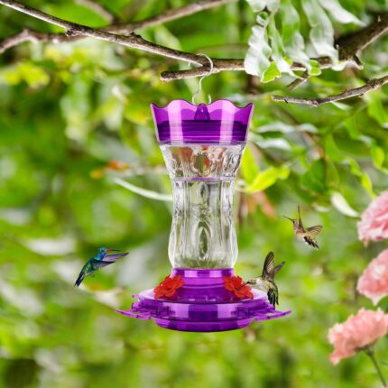 A vibrant purple glass hummingbird feeder with four flower-shaped feeding ports and a built-in ant moat, ready for hanging.